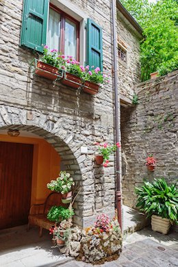 stone wall and entrance in tuscan neighborhood